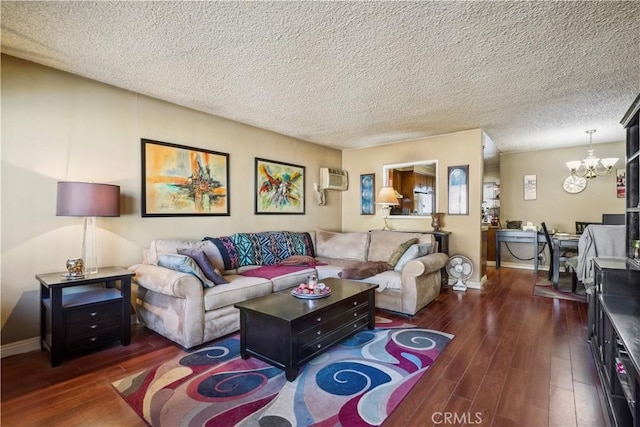 living room with dark wood-style floors, a wall mounted AC, baseboards, and an inviting chandelier