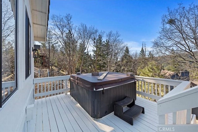 wooden deck with a hot tub