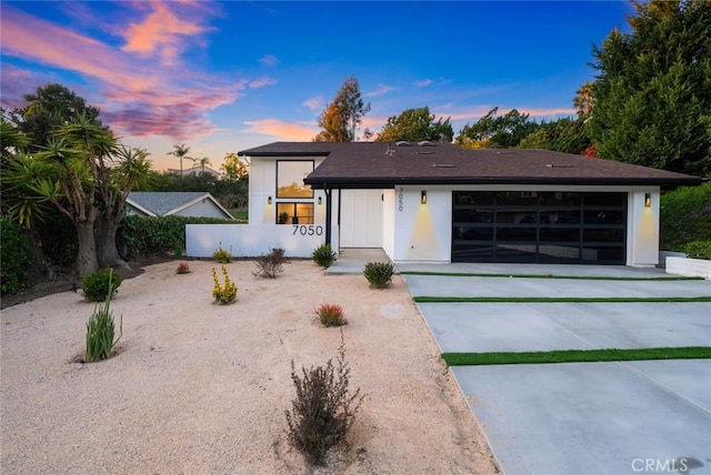 view of front of house with a garage and concrete driveway