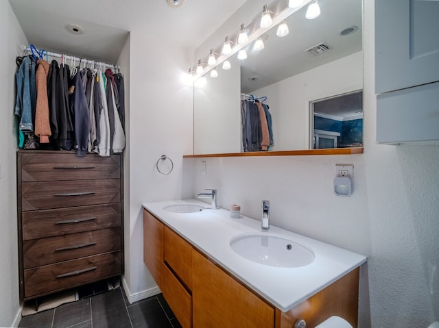 bathroom featuring double vanity, tile patterned flooring, a sink, and visible vents