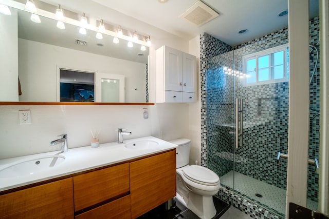 bathroom featuring toilet, a sink, and visible vents