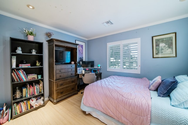 bedroom with ornamental molding, wood finished floors, and visible vents