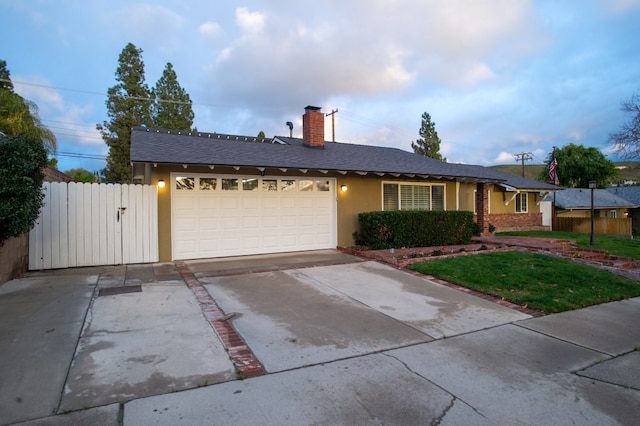 ranch-style house featuring concrete driveway, an attached garage, fence, and stucco siding