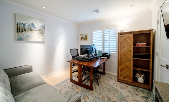 office area with visible vents, crown molding, light wood finished floors, and baseboards