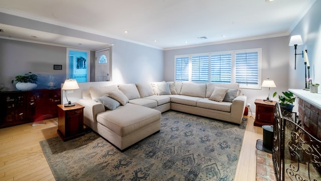 living room with light wood-style floors, recessed lighting, a fireplace, and crown molding