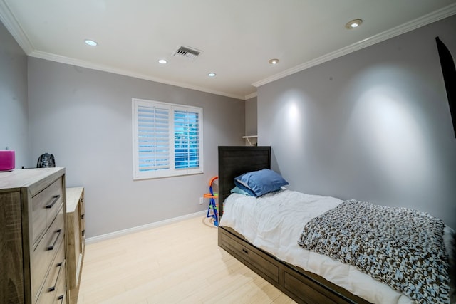 bedroom with light wood-type flooring, baseboards, visible vents, and crown molding