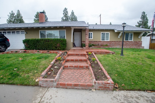 single story home with an attached garage, brick siding, fence, stucco siding, and a front lawn