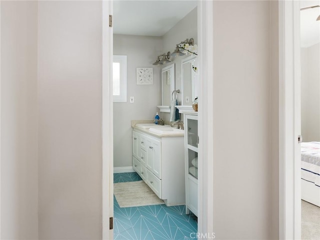 bathroom featuring ensuite bathroom and vanity