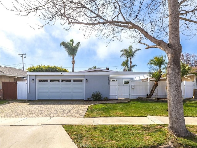 view of front facade featuring decorative driveway, a gate, and fence