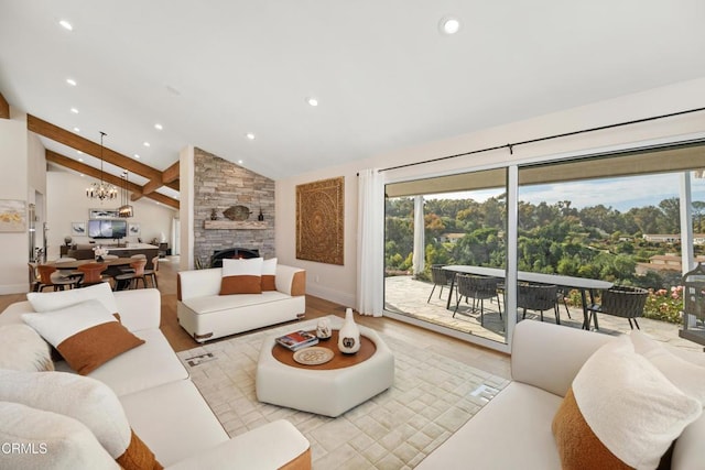 living area with lofted ceiling with beams, light wood-style floors, a fireplace, a chandelier, and recessed lighting