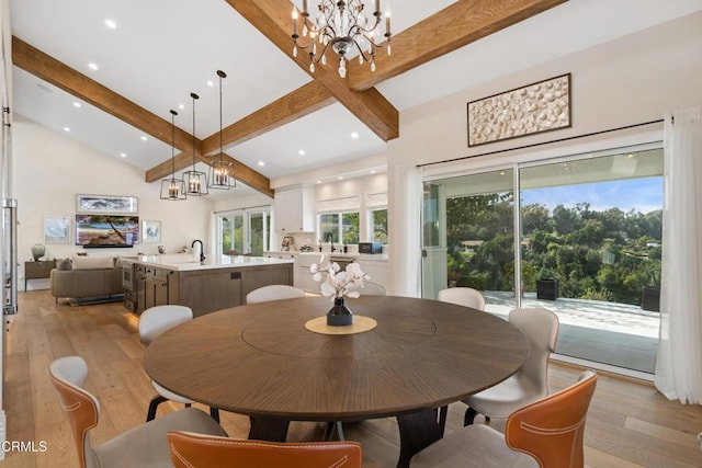 dining room featuring recessed lighting, a high ceiling, an inviting chandelier, light wood-style floors, and beamed ceiling