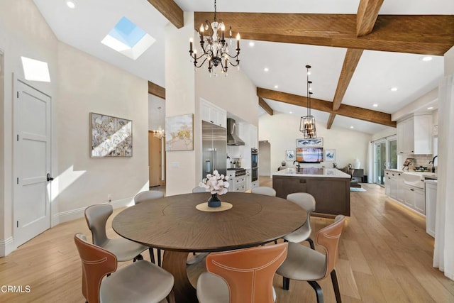 dining area featuring beamed ceiling, a skylight, light wood-style flooring, and baseboards