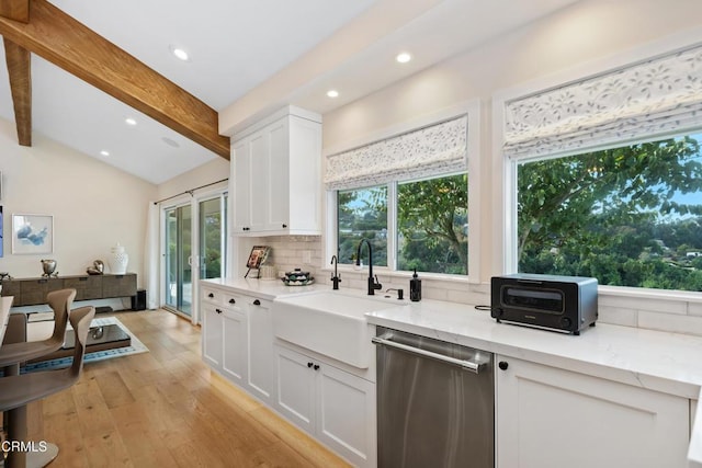 kitchen featuring decorative backsplash, dishwasher, lofted ceiling with beams, light wood-style floors, and a sink