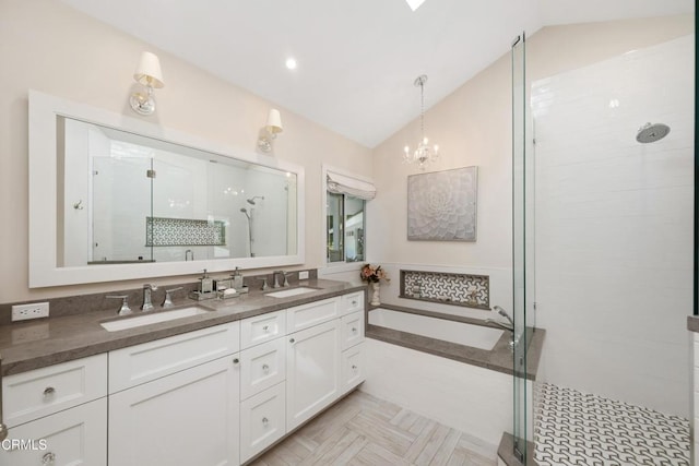 full bathroom featuring lofted ceiling, a shower stall, double vanity, and a sink