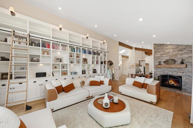 living area featuring recessed lighting, a fireplace, and light wood-style flooring