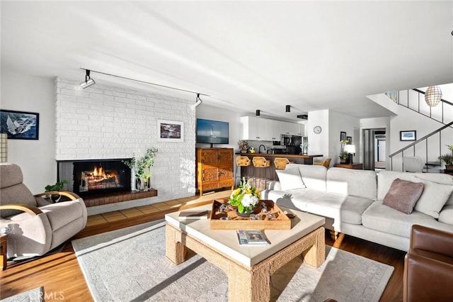 115 Bayside Pl Unit 115, Corona Del Mar, CA 92625 - living room with stairway, a fireplace, and wood finished floors