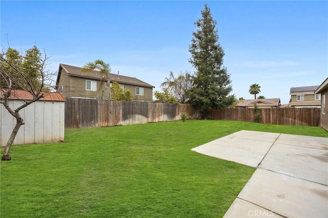 view of yard featuring an outbuilding, a fenced backyard, a patio, and a storage shed