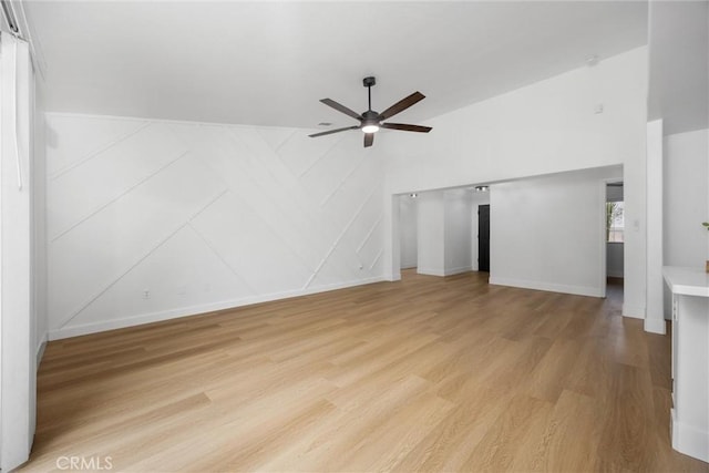 unfurnished living room with ceiling fan, light wood-style flooring, and baseboards