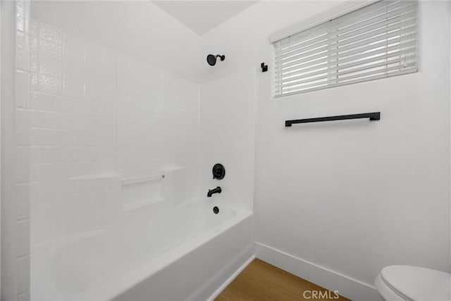 full bath featuring toilet, wood finished floors, bathing tub / shower combination, and baseboards