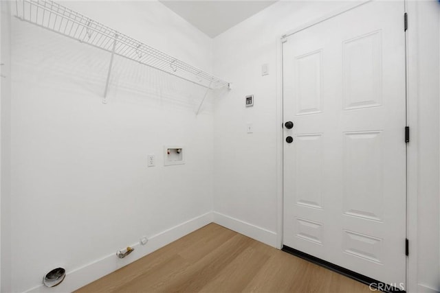 laundry room featuring hookup for a washing machine, hookup for a gas dryer, laundry area, baseboards, and light wood-type flooring