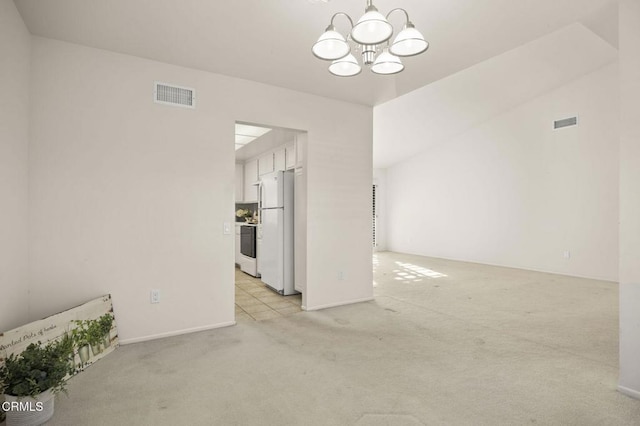 unfurnished room featuring a chandelier, visible vents, and light carpet