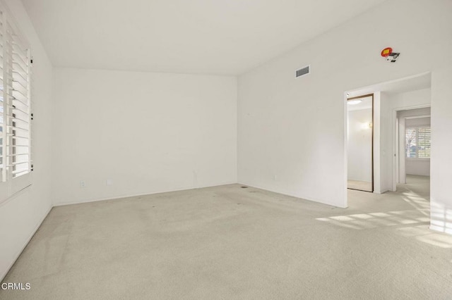 spare room with light carpet and visible vents