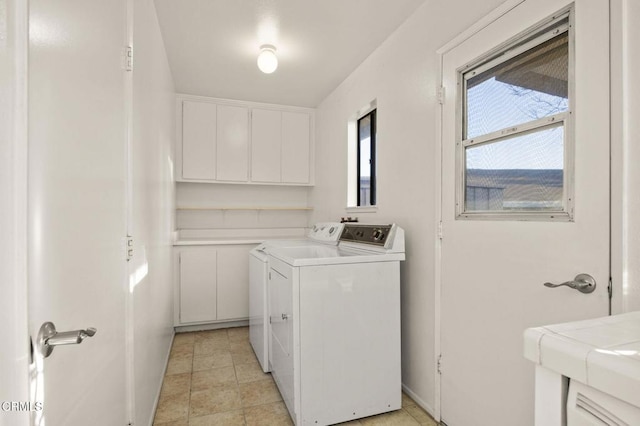 laundry room with laundry area, light tile patterned flooring, and washer and dryer