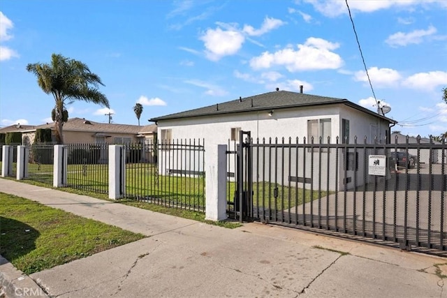 view of gate featuring a fenced front yard and a yard