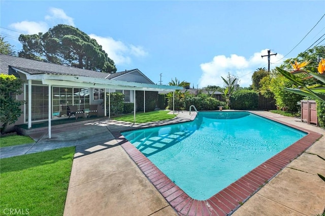 view of pool featuring a lawn, a patio area, fence, and a fenced in pool