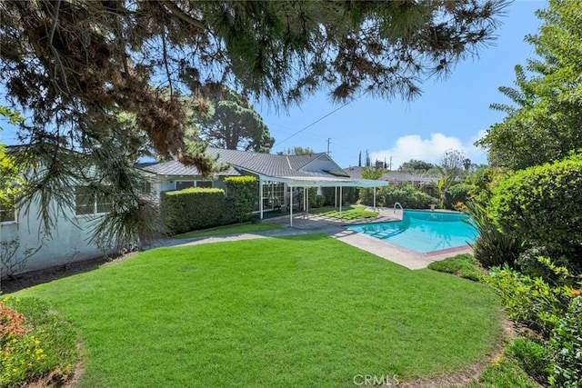 pool featuring a yard and a patio area