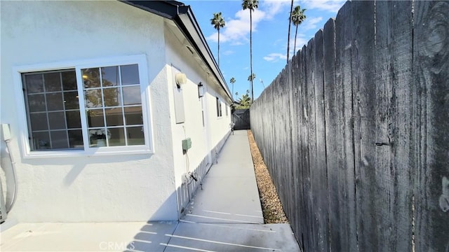 view of property exterior featuring fence and stucco siding