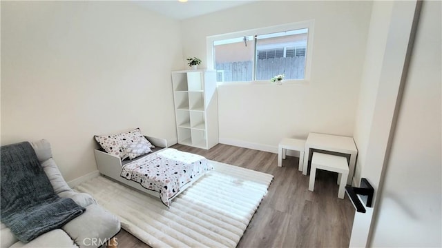 bedroom with light wood-style flooring and baseboards