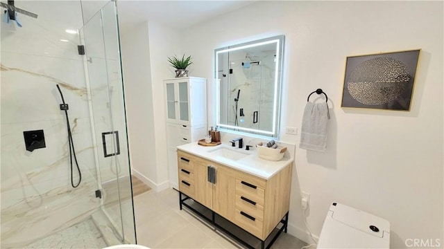 bathroom featuring a marble finish shower, vanity, and toilet