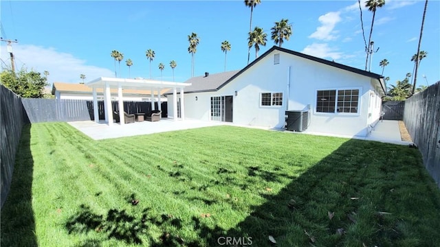 back of house with central air condition unit, a fenced backyard, a lawn, and stucco siding