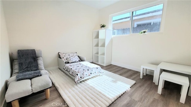 sitting room featuring baseboards and wood finished floors