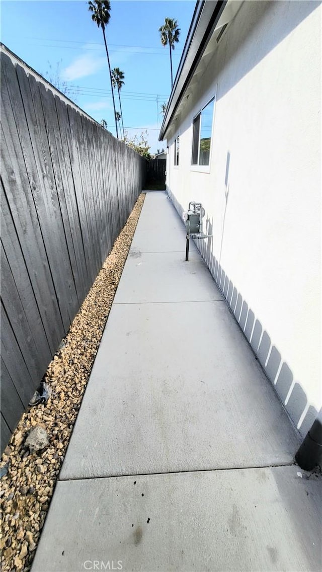 view of side of property with a patio and a fenced backyard