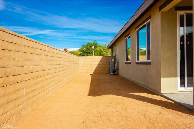 67813 Rio Vista Dr, Cathedral City, CA 92234 - view of side of property featuring stucco siding, a fenced backyard, and a patio