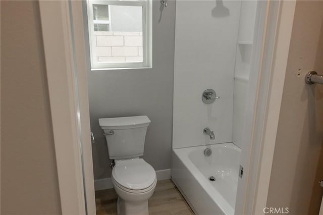 full bathroom with shower / bath combination, baseboards, toilet, and wood finished floors