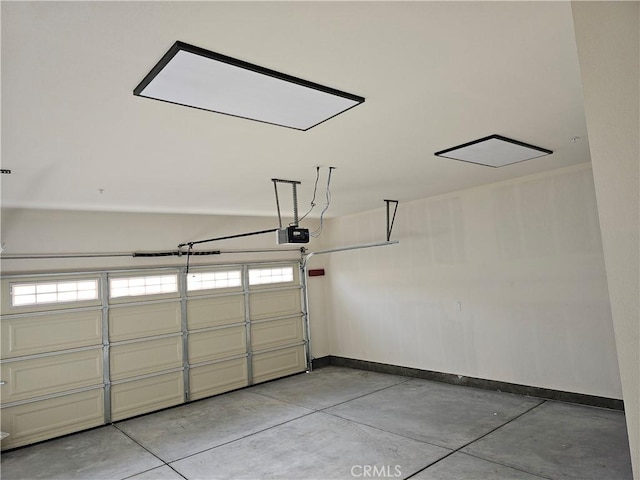 garage featuring baseboards and a garage door opener