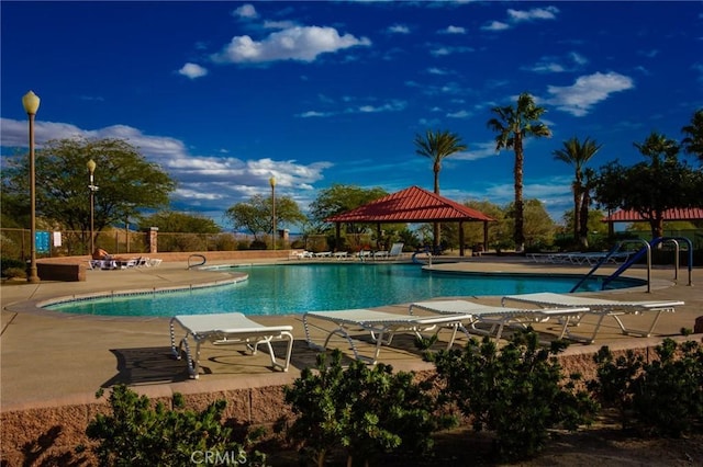 community pool featuring a patio, a gazebo, and fence