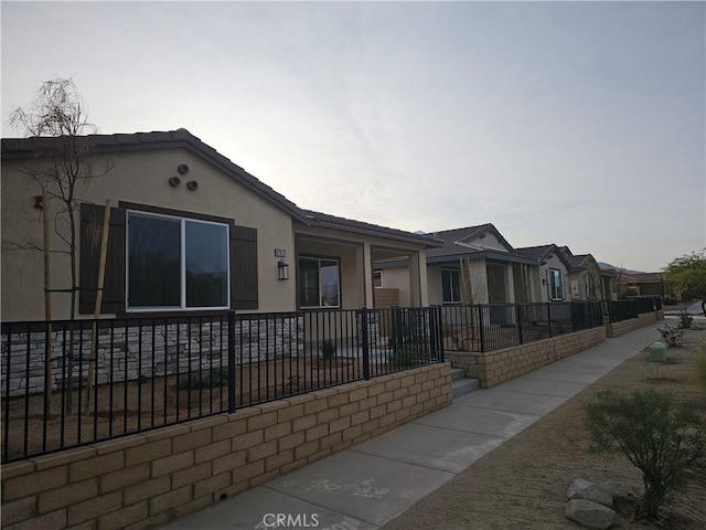 view of front facade with a fenced front yard and stucco siding