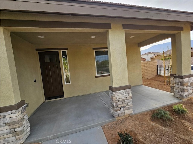 67813 Rio Vista Dr, Cathedral City, CA 92234 - property entrance with stucco siding, a patio, and stone siding