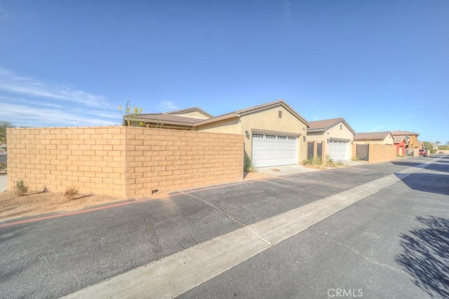 67813 Rio Vista Dr, Cathedral City, CA 92234 - ranch-style home featuring a garage, stucco siding, and driveway