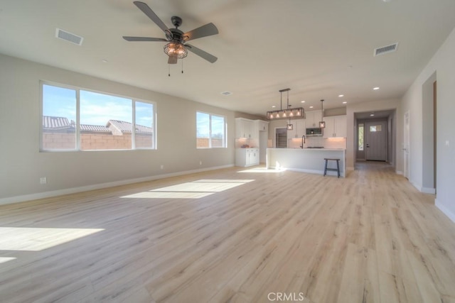 67813 Rio Vista Dr, Cathedral City, CA 92234 - unfurnished living room with light wood-style floors, a ceiling fan, and recessed lighting