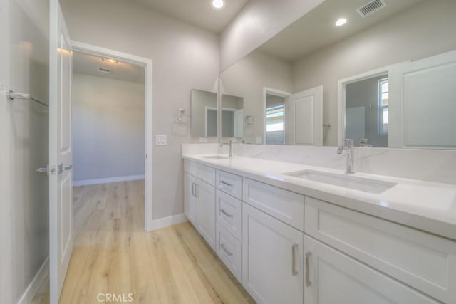 67813 Rio Vista Dr, Cathedral City, CA 92234 - bathroom with double vanity, wood finished floors, and recessed lighting
