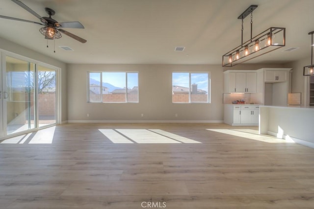 67813 Rio Vista Dr, Cathedral City, CA 92234 - unfurnished living room with ceiling fan and light wood-style floors