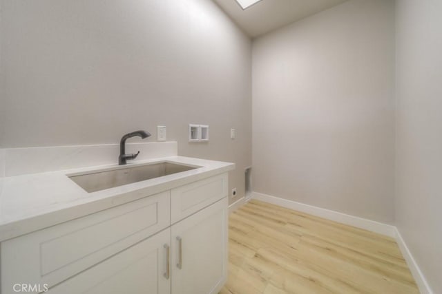 67813 Rio Vista Dr, Cathedral City, CA 92234 - washroom with light wood-style flooring, cabinet space, and washer hookup