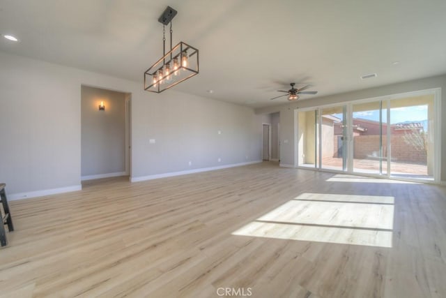 67813 Rio Vista Dr, Cathedral City, CA 92234 - unfurnished living room with light wood-style flooring and ceiling fan