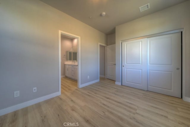 67813 Rio Vista Dr, Cathedral City, CA 92234 - unfurnished bedroom with light wood-style flooring, a closet, and connected bathroom