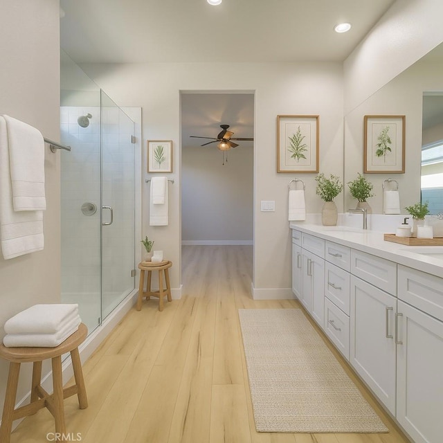 67813 Rio Vista Dr, Cathedral City, CA 92234 - full bathroom with double vanity, a stall shower, a ceiling fan, wood finished floors, and recessed lighting